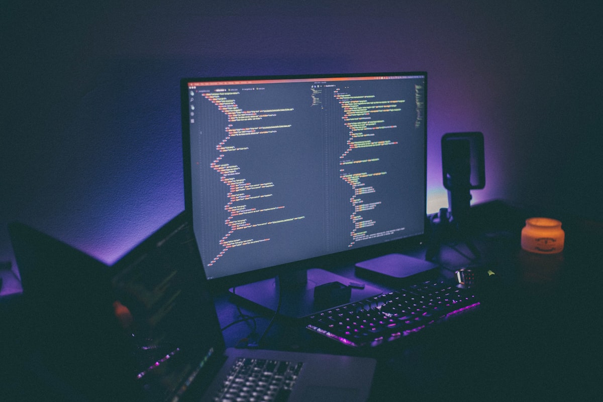 Illuminated monitor on a dark desk — the kind of setup where translation and editing work gets done